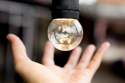 Close-up of hand holding glass of crystal ball