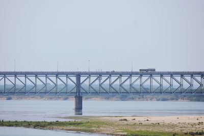 Bridge over sea against clear sky