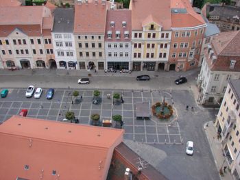 High angle view of vehicles on road amidst buildings in city