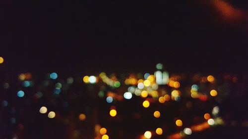 Defocused image of illuminated city at night