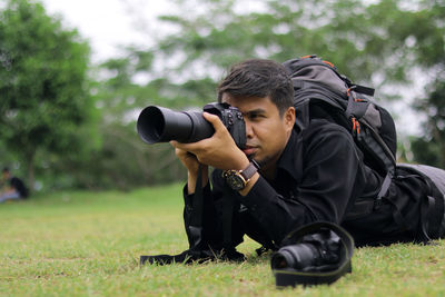 Man photographing on field