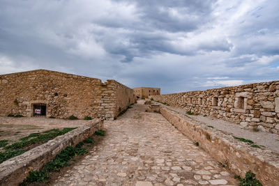 Old ruin building against cloudy sky