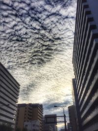 Low angle view of building against cloudy sky