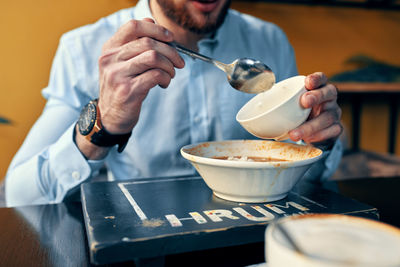 Midsection of man preparing food in kitchen