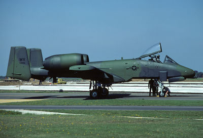 Milirary airplane on runway against clear sky