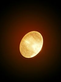 Low angle view of illuminated moon against clear sky at night