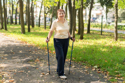 Full length portrait of a woman standing on ground