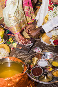 High angle view of hands on table