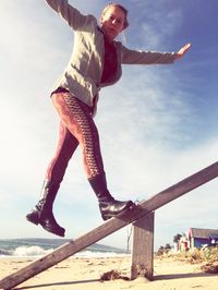Full length of woman standing on land against sky