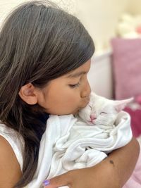 Close-up of girl looking away at home