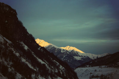 Scenic view of snow covered mountains against sky