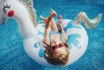 High angle view of young woman in swimming pool