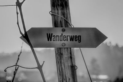 Low angle view of road sign against sky