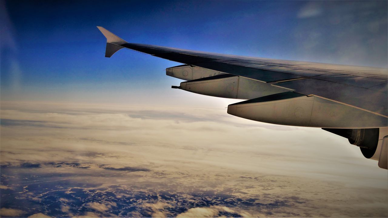 AIRPLANE WING AGAINST SKY