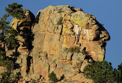 Low angle view of rock formation on land against clear sky