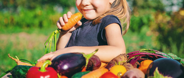 Portrait of young woman picking apple