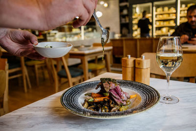 Midsection of man having food in restaurant