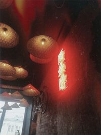 Low angle view of illuminated lanterns hanging on ceiling