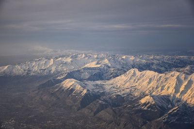 Wasatch front rocky mountain range aerial snow capped peaks winter urban salt lake city utah usa