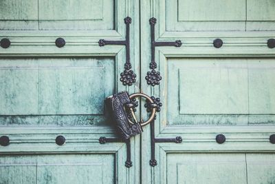 Close-up of padlock hanging on closed door