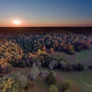 Scenic view of field against clear sky at sunset