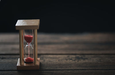 Close-up of clock on table at home