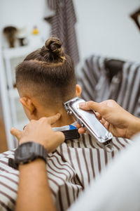 Midsection of man using mobile phone