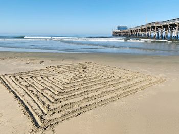 Scenic view of beach with pattern in sand