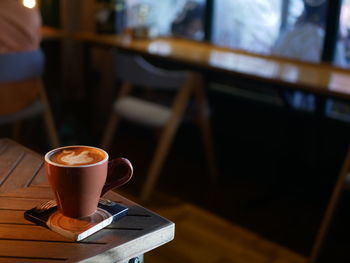 One cup of coffee latte in the table 