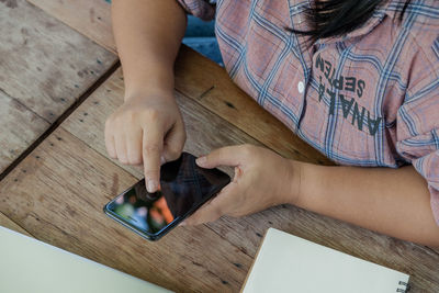 High angle view of child sitting on table