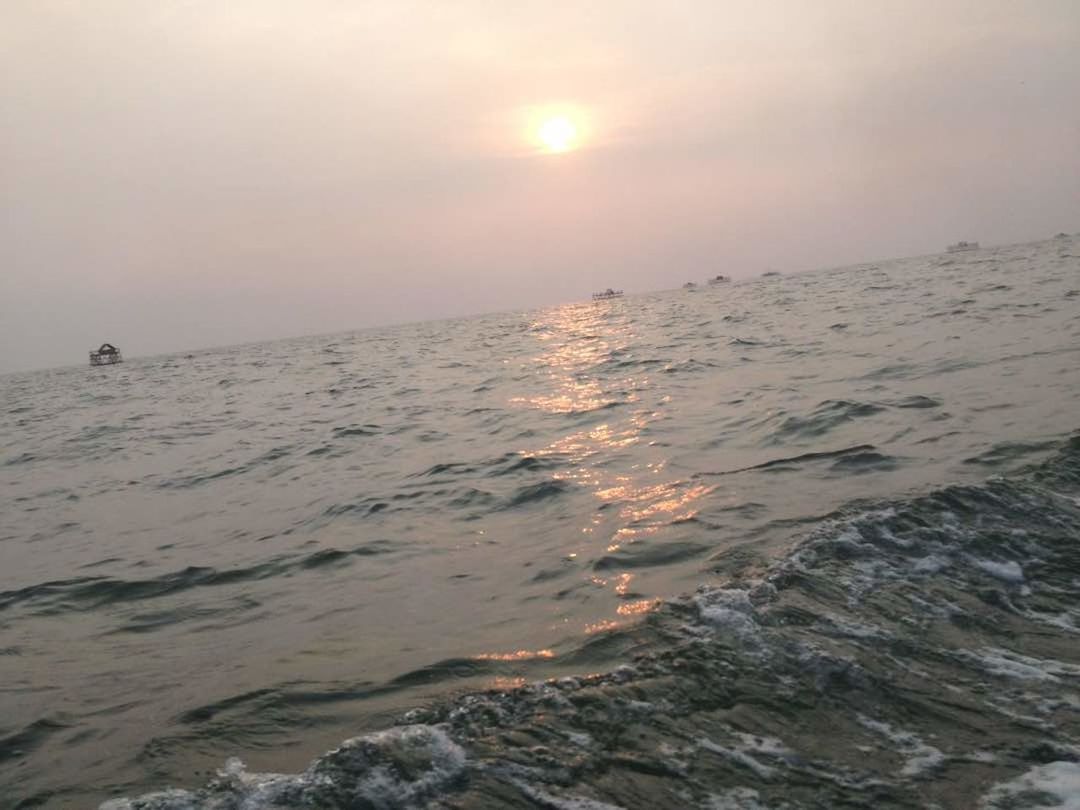 SCENIC VIEW OF BEACH AGAINST SKY AT SUNSET