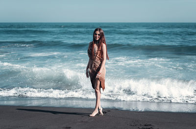 Full length of women standing on beach