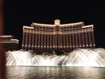 Water fountain in city at night