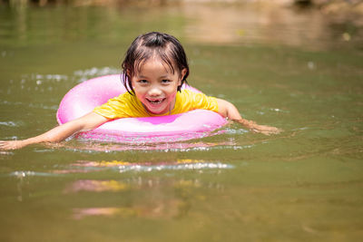 Portrait of happy girl in swimming pool