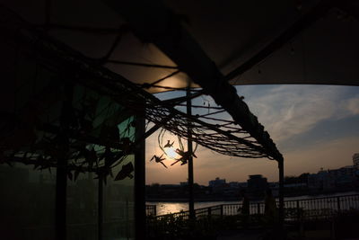 Low angle view of silhouette bridge against sky during sunset