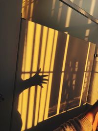 Low angle view of person hand on glass window