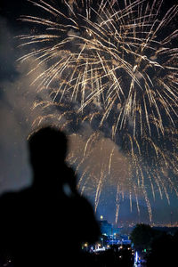 Low angle view of firework display at night