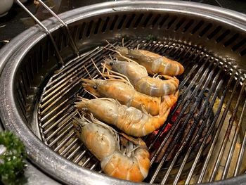 High angle view of fish on barbecue grill