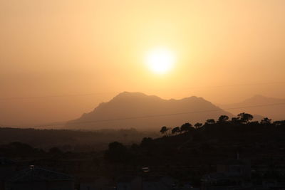 Scenic view of silhouette mountains against sky during sunset