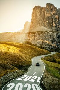 Road passing through mountains against sky