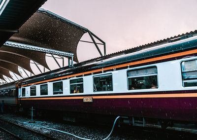 Train at railroad station against sky