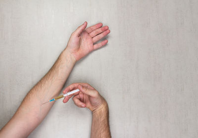 Directly above shot of person hand on wall