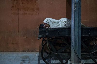Man sleeping on abandoned wall