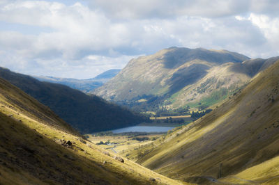 Scenic view of valley and mountains against sky