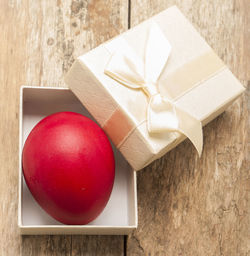 Close-up of red egg in box on table