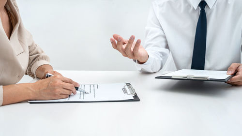 Midsection of business colleagues working on table