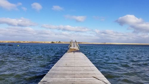 Pier over sea against sky