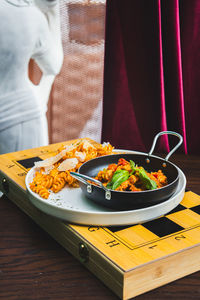 Midsection of woman having food on table