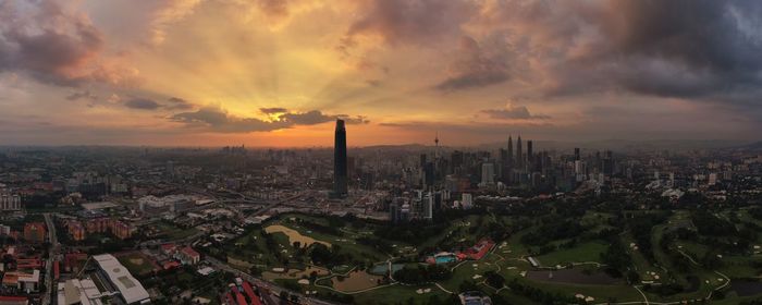 High angle view of modern buildings against sky during sunset