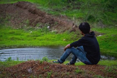 Rear view of boy on field